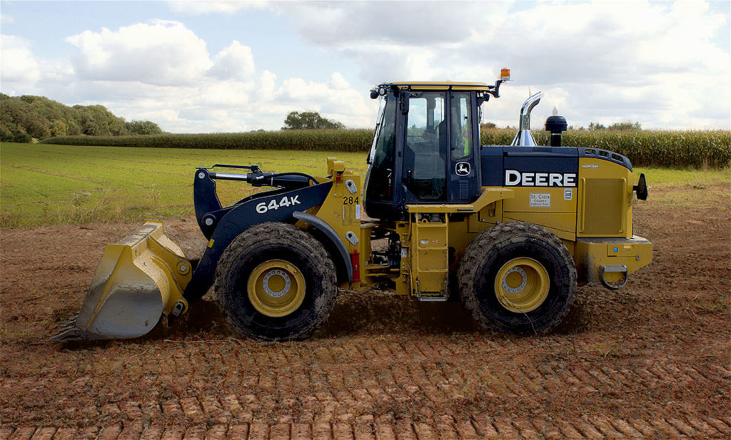 John Deere front end loader in profile, getting ready to beat Old Man