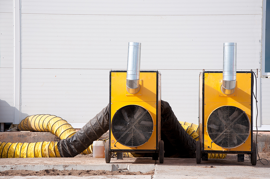 Large diesel industrial heaters at a construction site. Equipment for heating a room in a cold period of time. Heat fans as an alternative to classic room heating. Industrial background